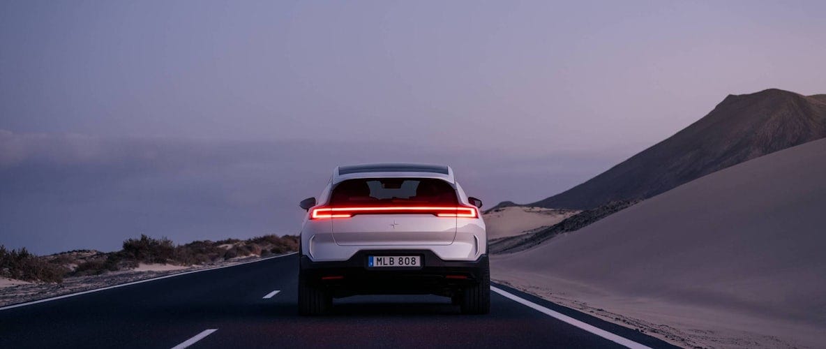 Polestar 3 viewed from behind on a road at dusk.